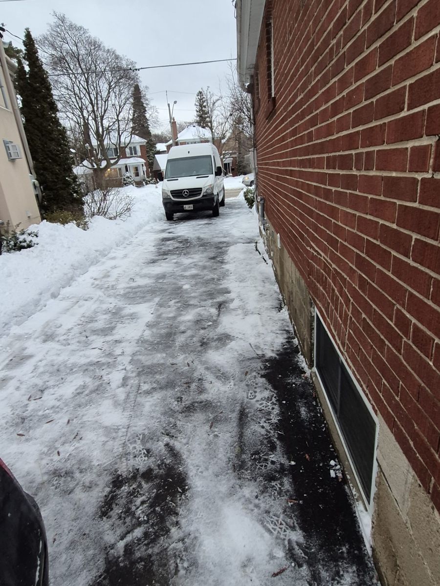 Toronto driveway beside a brick house after snow clearing